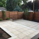 New wood fence with a new concrete patio