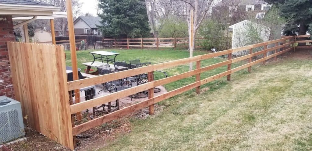 Wood field fence installed in a yard in Denver, Co