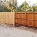 Newly installed wood privacy fence next to an already installed wood privacy fence