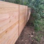 Closeup of a new wood fence in a backyard