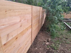 Closeup of a new wood fence in a backyard