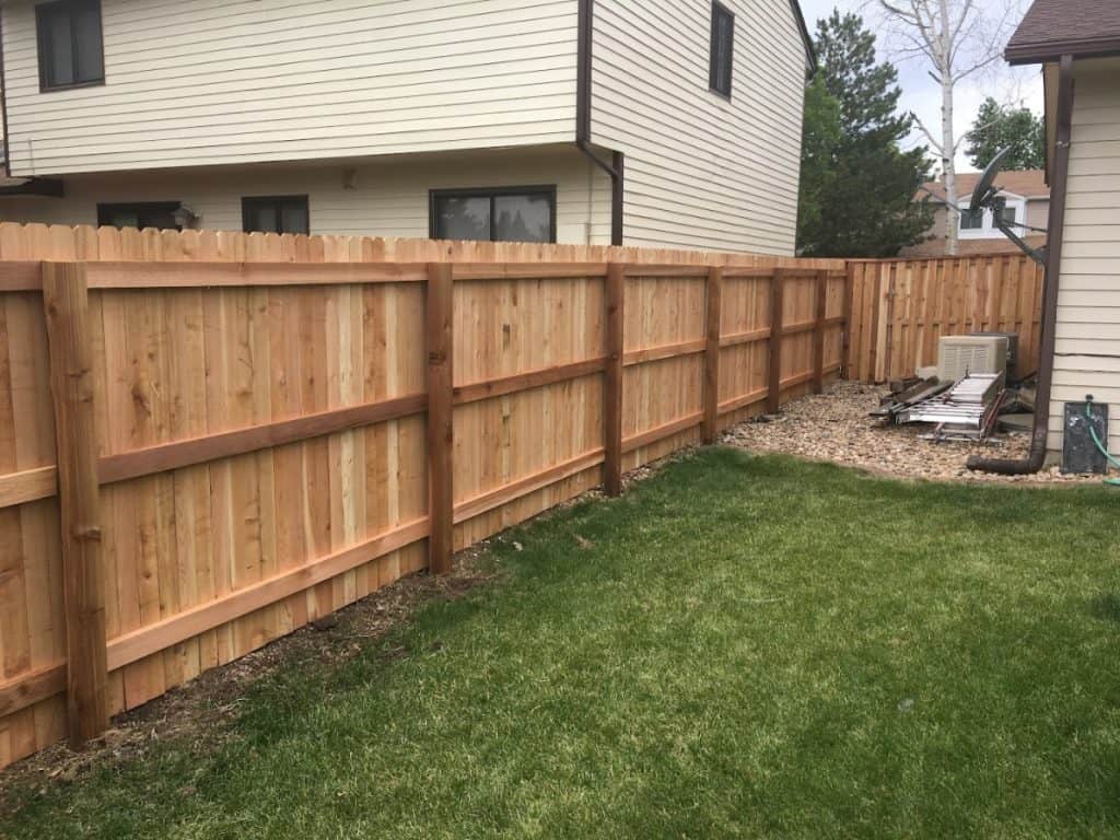 Newly installed wood fence in a backyard